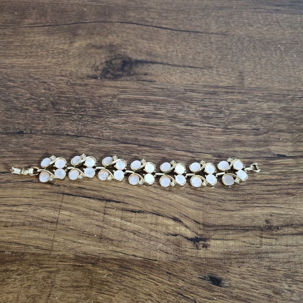link bracelet featuring white oval cabochon stones and clear rhinestone accents.